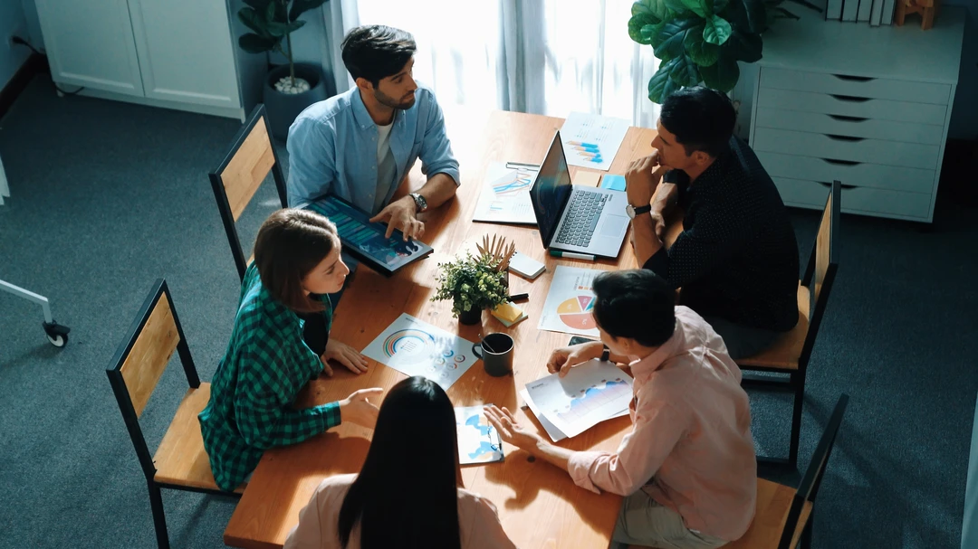 Business team working together to plan marketing strategy while looking at data analysis Business team working together to plan marketing strategy while looking at data analysis